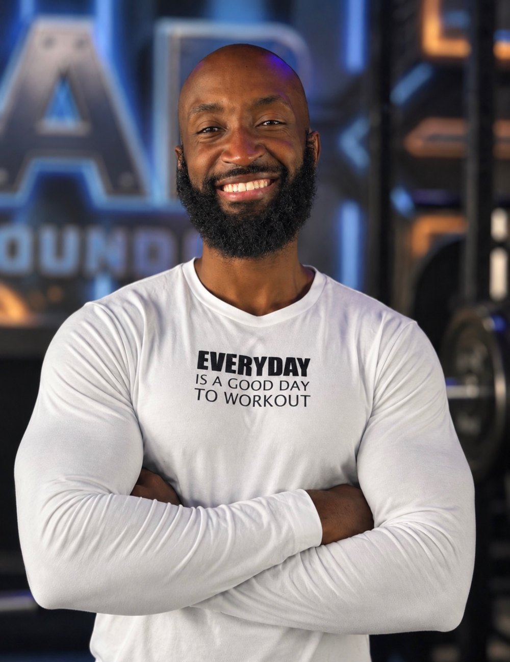 ONE10 Strong coach smiling in a gym, wearing a white training shirt